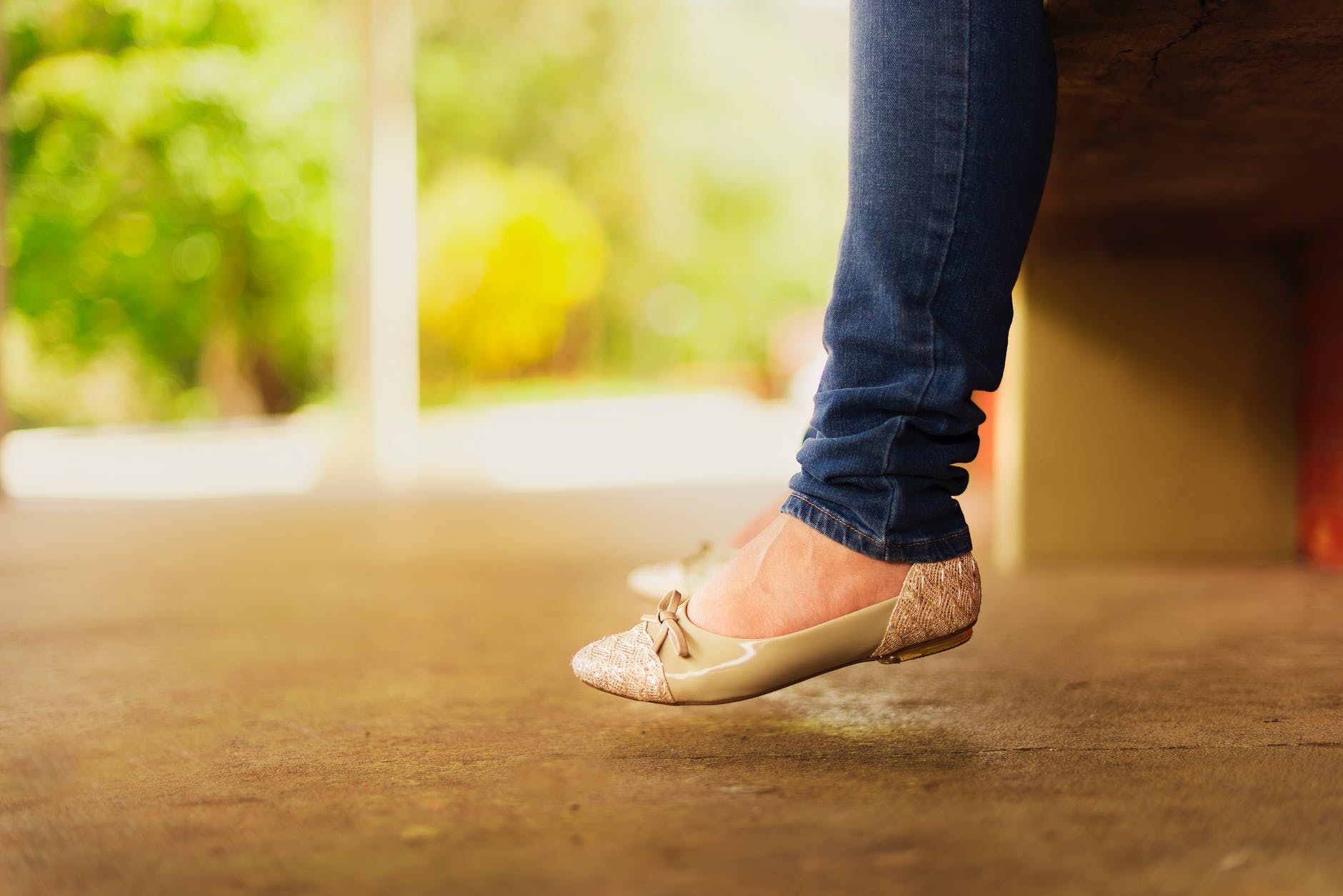 person wearing beige flats while sitting on bench